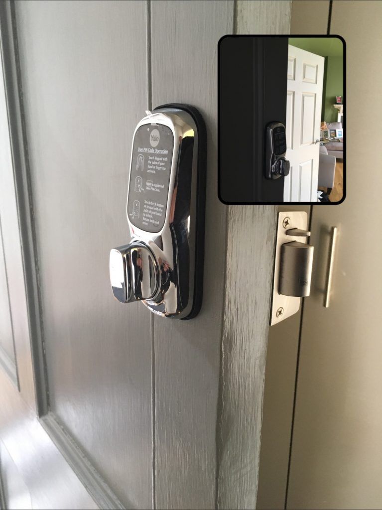 Smart Locks installed on a wooden front door.